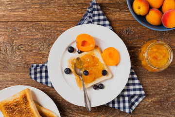 Breakfast. Toasts with cherry or peach jam and fresh fruit.