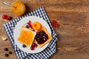 Breakfast. Toasts with cherry or peach jam and fresh fruit.
