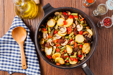 Fried pan vegetables, with mushrooms and dried tomatoes. Seasoned with a mix of herbs.
