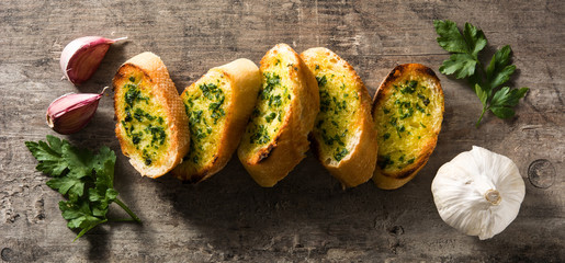 Garlic bread on wooden table. Panoramic view