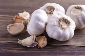Garlic Cloves and Garlic Bulb on vintage wood background