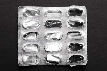 Empty pill box on black background