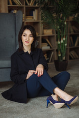 Modern business woman in the office sitting on the sofa