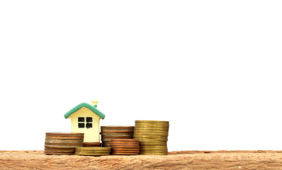 Mini house on stack of coins. Concept of Investment property.