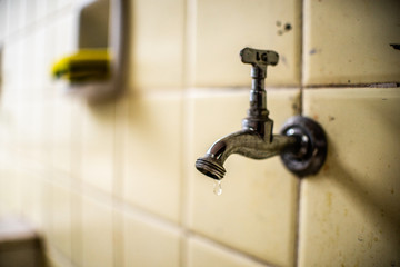 Old faucet dripping water