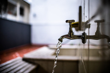 Old faucet pouring water