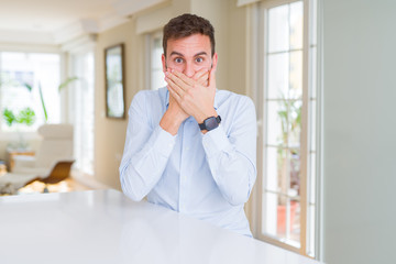Fototapeta premium Handsome business man shocked covering mouth with hands for mistake. Secret concept.
