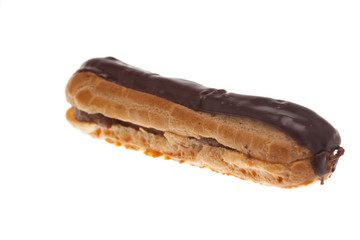 Delicious chocolate eclaire isolated over white background