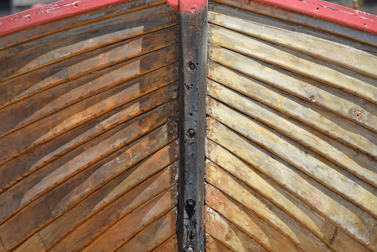 Close up of colourful wooden fishing boat bow