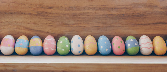 colorful easter eggs on wooden background with copy space.