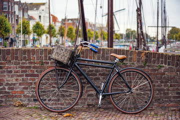 Fototapeta na wymiar The view of old bicycle parked on the stone bridge