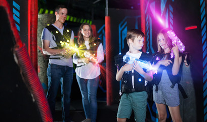Boy and girl in beams on lasertag arena