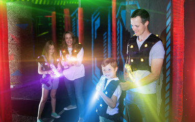 Fototapeta na wymiar Father with son on lasertag arena in beams