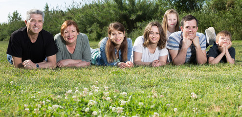 Ordinary family taking photos on the lawn