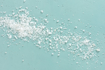 Coarse sea salt on the blue textured table