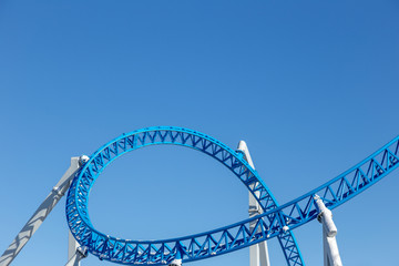 rollercoaster against blue sky