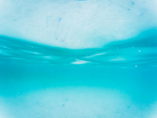Fototapeta na wymiar abstract blur, Blue sea waves from underwater background, light shining through