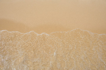 Soft ocean wave on sandy beach