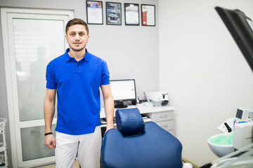Obraz premium Portrait of a dentist, young man at his workplace in the dental clinic.