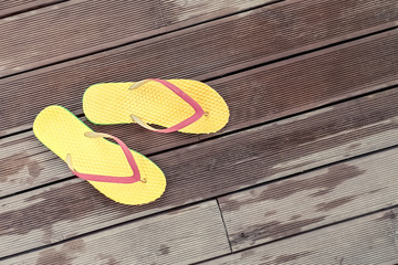 yellow slippers against the background of a wooden floor