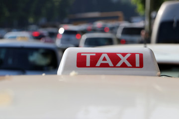 Taxi light sign or cab sign in white and red color with white text on the car roof