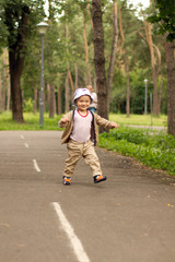 Fototapeta premium Baby Learning to Walk in Park