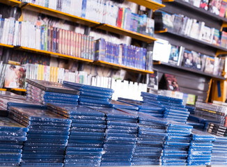 CDs and DVDs on piles at store