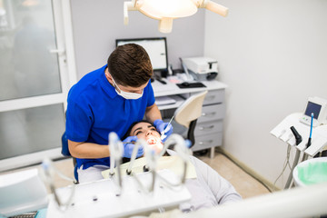 Fototapeta premium Dentist check-up teeth to young woman patient in dental clinic.