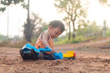 childen playing toy on soil outdoor