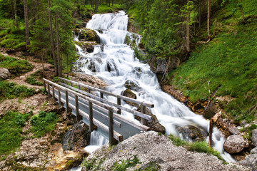 Waterfall in the forest, Fanes Cascade (Cascate di Fanes) in Dolomites