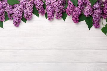 A bouquet of lilacs on white boards