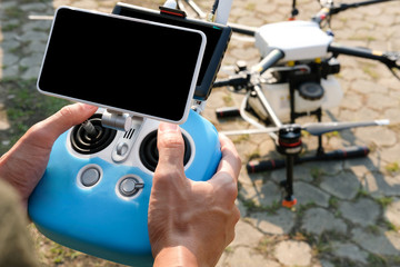 man controlling agriculture drone. remote controller