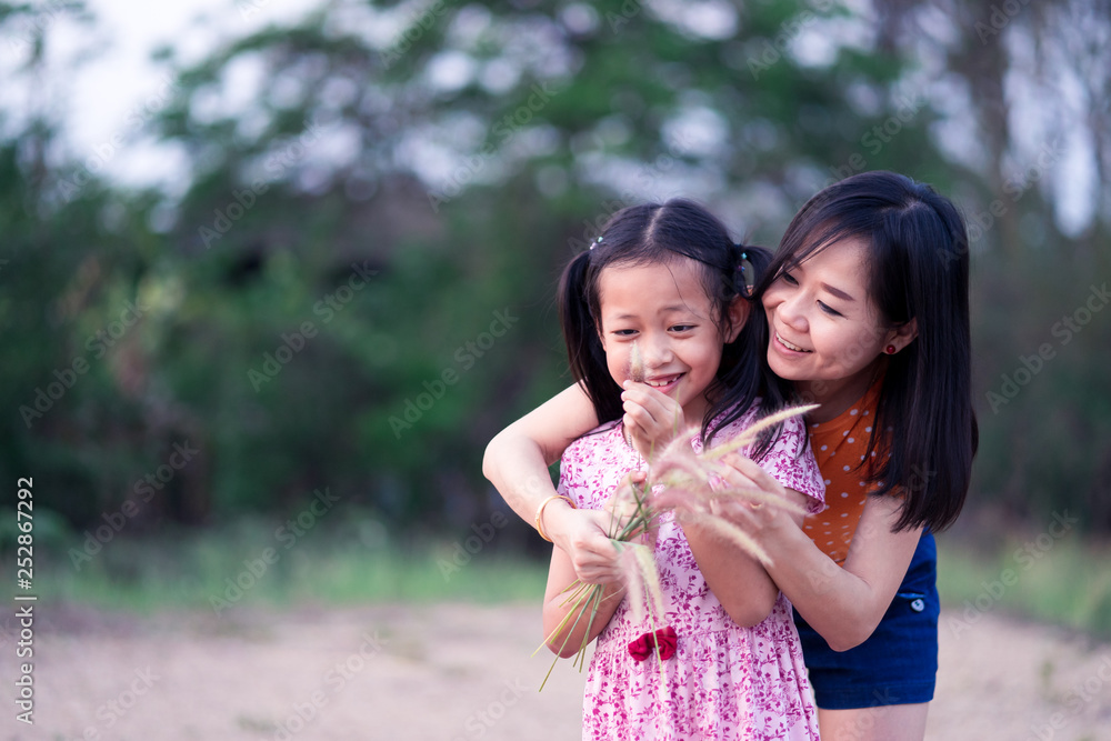 Wall mural asian little daughter have fun and happy with her mother