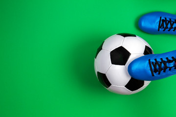 Soccer football player with soccer ball on green background