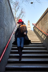 Girl descends and enters the Cairoli Metro Station in Milan Italy