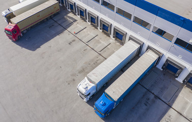 Aerial view of trucks unloading in logostics center