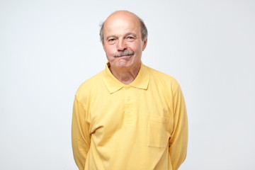 Nervous doubtful man frowning biting lips having puzzled look