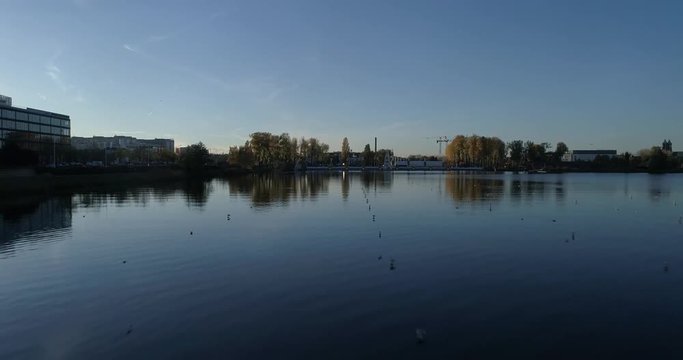 Aerial drone footage from the lake level to above the city 4K slow moton 50fps