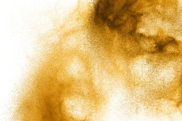 Abstract brown dust explosion on  white background. Brown powder splattered on background.