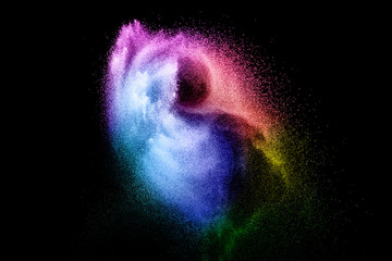 Abstract multi color powder explosion on black background.  Freeze motion of colorful dust  particles splash. Painted Holi.