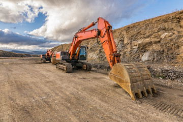 Excavator building a road next to a slope