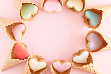 Valentine's day background. Ice cream waffle cone with ginger cookie in shape heart on pink background. Valentine day concept, design. Flat lay, top view, copy space 