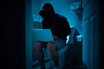 Hacker sit on the toilet, concept of everywhere can hack
