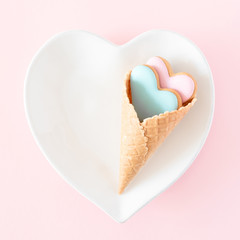 Valentine's day background. plate with ginger cookie in shape heart on pink background. Valentine day concept, design. Flat lay, top view, copy space