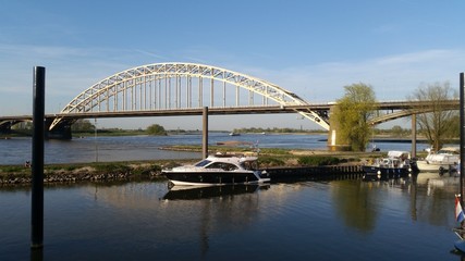 Fototapeta na wymiar Boat near a bridge in a canal