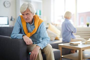Fototapeta premium Portrait of modern senior couple fighting focus on sad man looking at camera, copy space