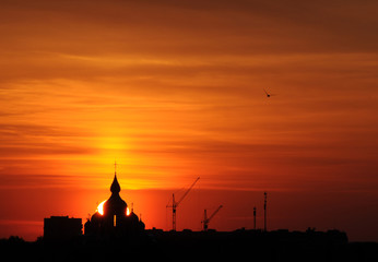 Fototapeta na wymiar The silhouette of ortodox church in sunrise