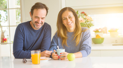 Beautiful romantic middle age couple having healthy breaskfast in the morning at home