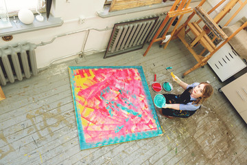 beautiful artist paint a huge canvas