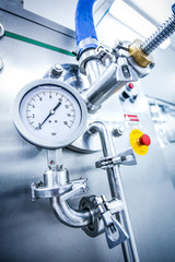 Steel pipelines and valves on trucks transport milk at factory